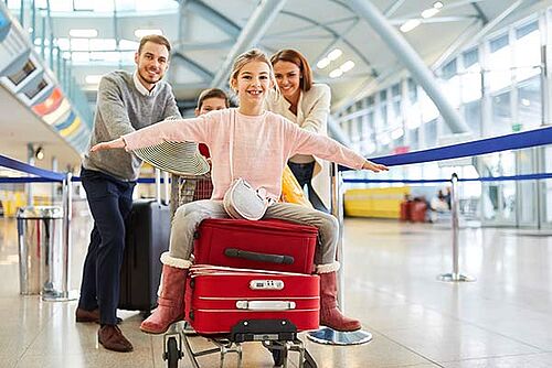 Luggage Tested for Quality and Safety Family pushing luggage in an airport