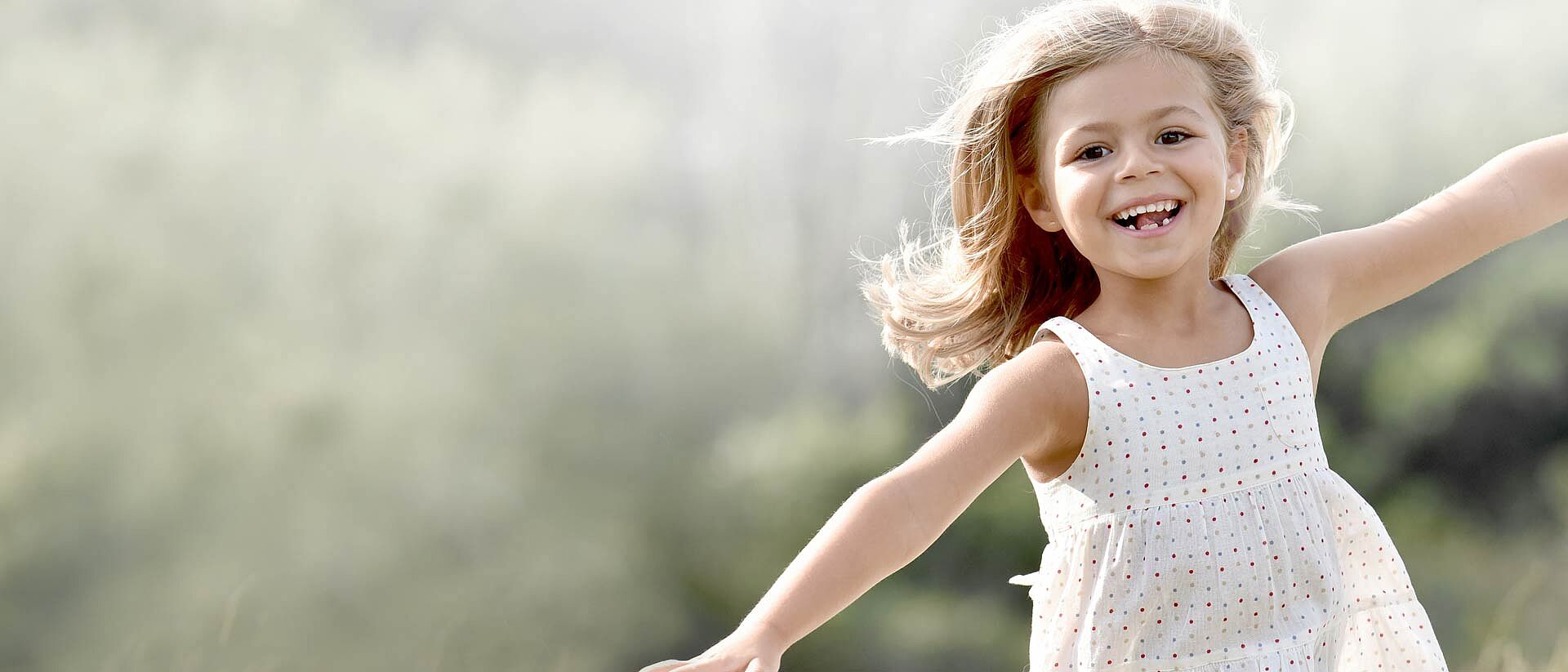 girl in certified dress running in field of wheat