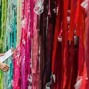 Man checking colorful fabric samples