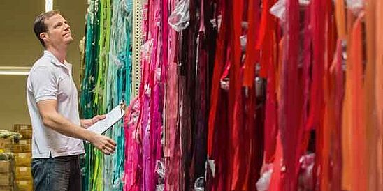 Man checking colorful fabric samples