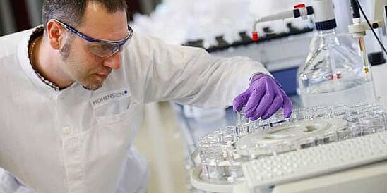 Lab technician holding a tube in Hohenstein lab