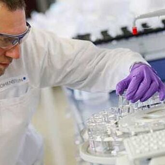 Lab technician holding a tube in Hohenstein lab