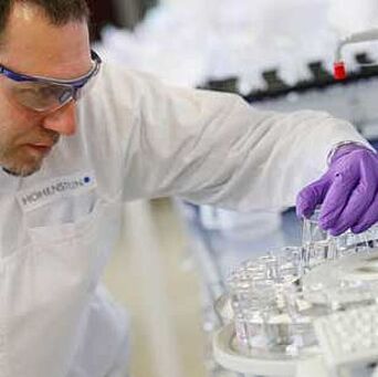 Lab technician holding a tube in Hohenstein lab