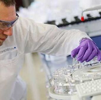 Lab technician holding a tube in Hohenstein lab