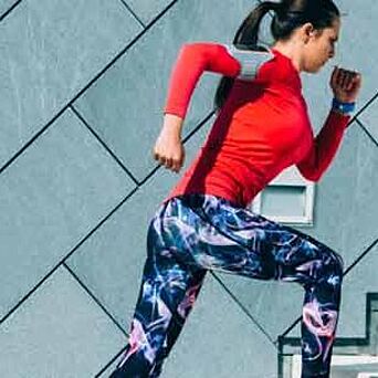 Woman running in performance gear, plus the Hohenstein Quality Label