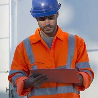 Worker in hardhat and reflective PPE