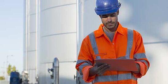 Worker in hardhat and reflective PPE