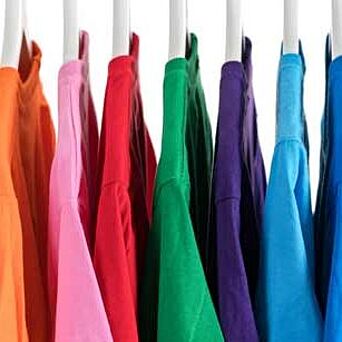 shirts in many colors hanging on a rack