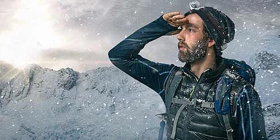 Hiker under snow on a mountain