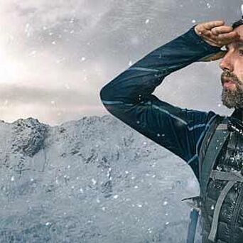 Hiker under snow on a mountain