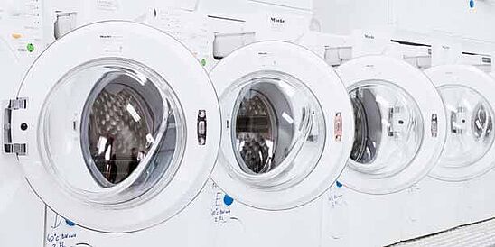 Row of home laundry machines in Hohenstein lab