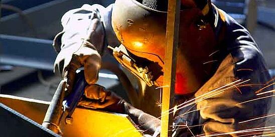 welder in PPE and helmet