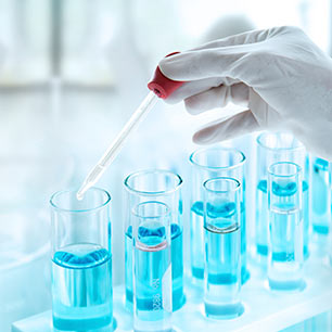 Test tubes containing blue extraction solution in a lab rack.