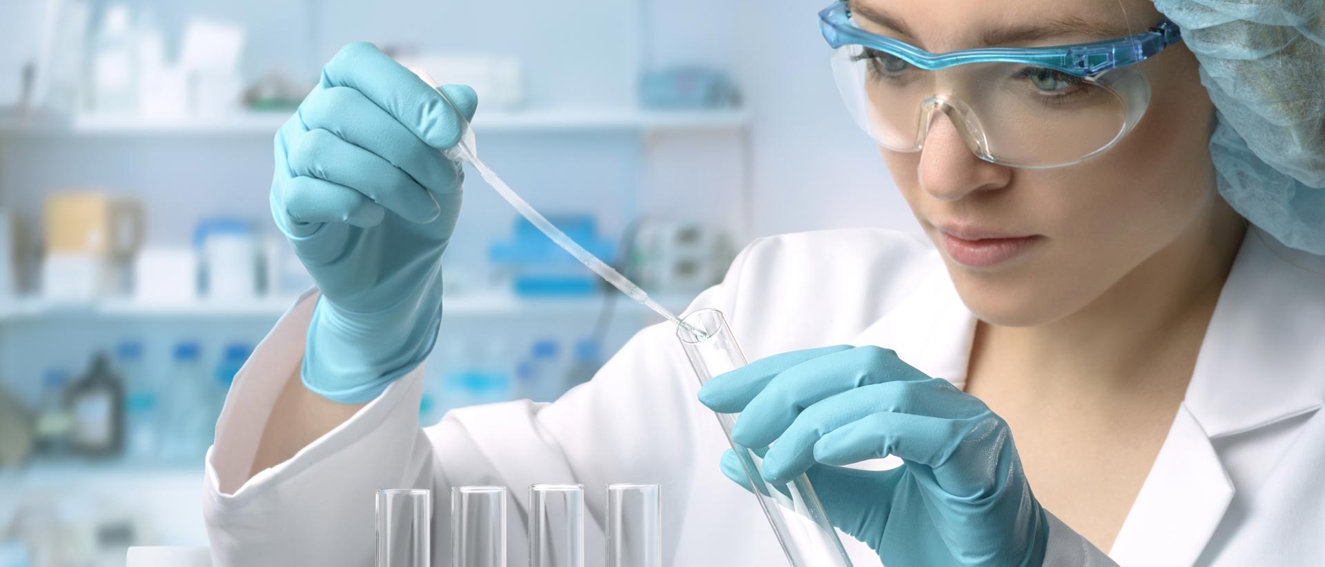 chemist holding chemicals in test tube in analytical testing lab