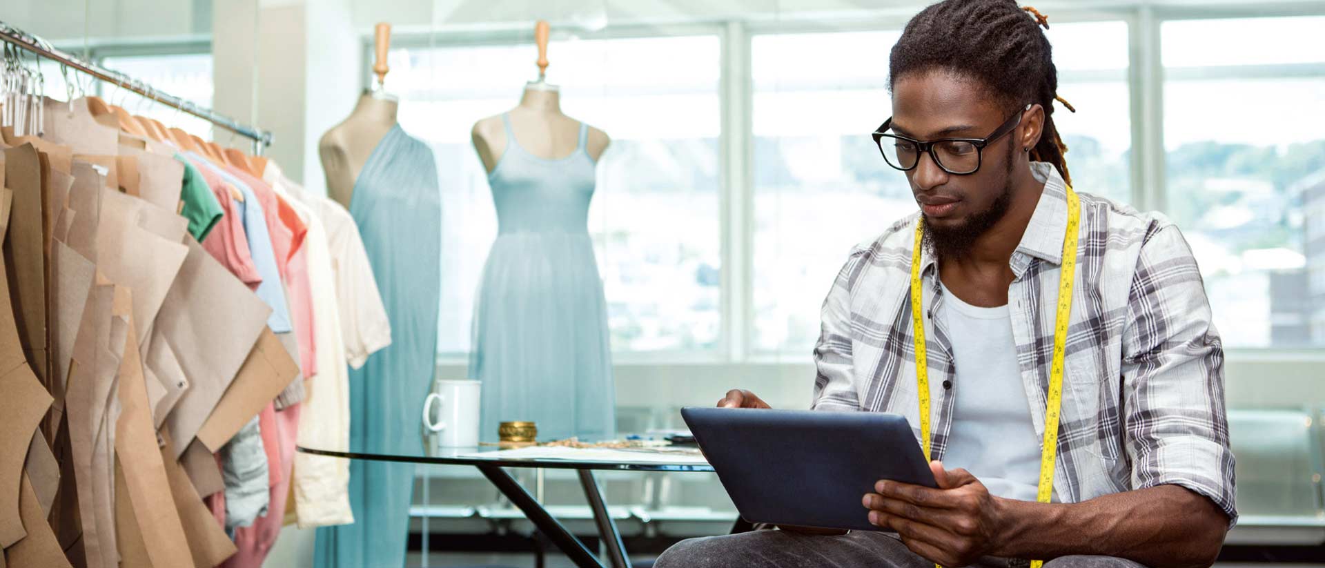 Male apparel designer using a tablet