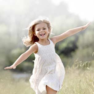 girl in white dress running outside