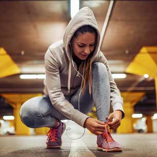 Runner kneeling to tie shoes