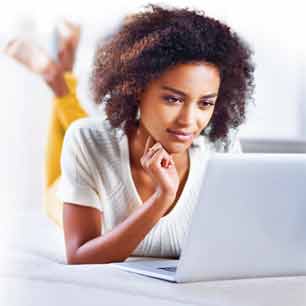 Woman looking at computer for answers about certification