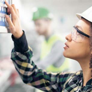 Textile worker wearing safety glasses and hard hat