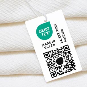 OEKO-TEX® MADE IN GREEN hangtag on stack of white towels