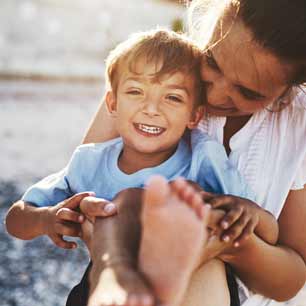 Mom holding young boy in blue shirt