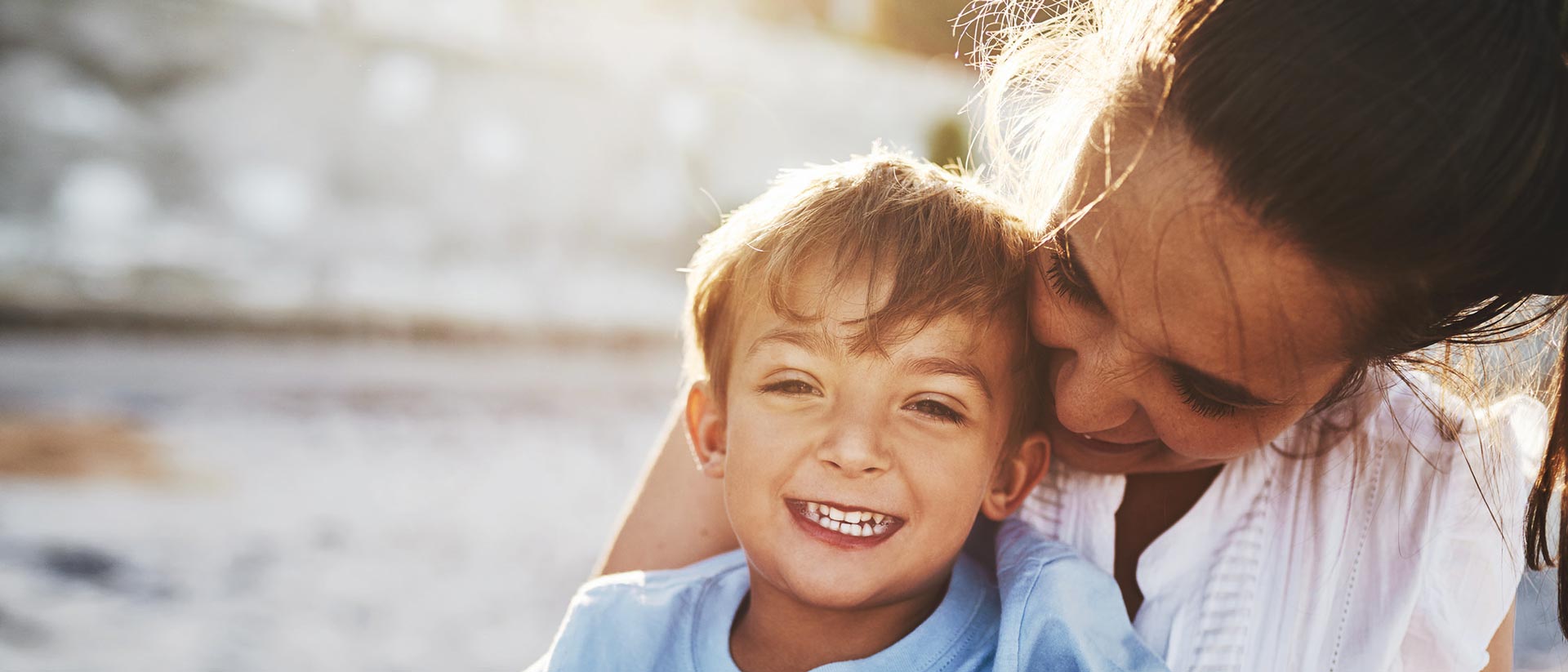 Mom and son laughing together outside