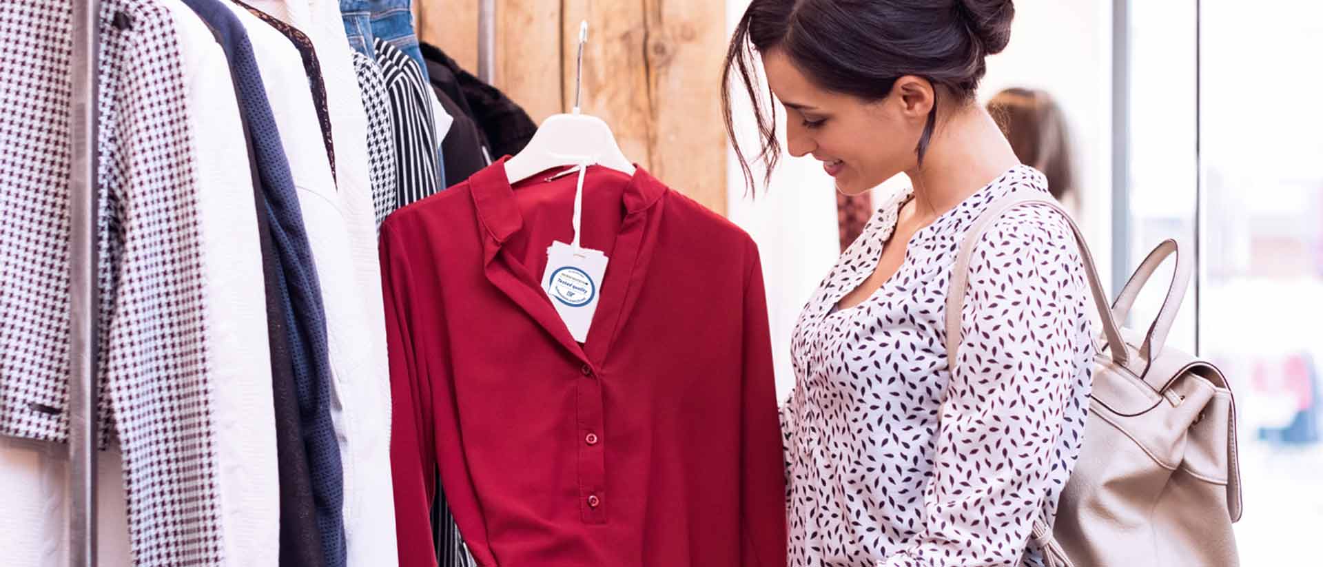 Shopper looking at apparel tag in store