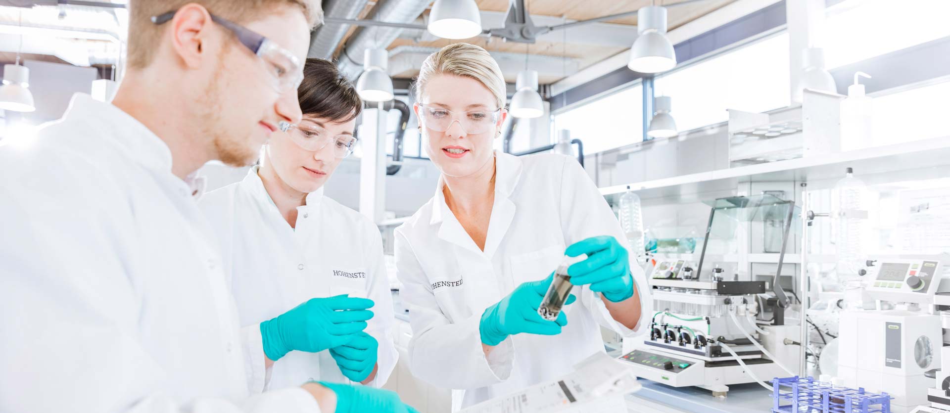 3 Hohenstein lab technicians analyzing a test sample in the lab