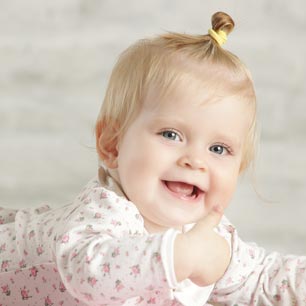 Smiling baby lying on floor