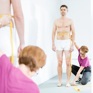 Man being measured in front of a mirror at Hohenstein Fitting Lab