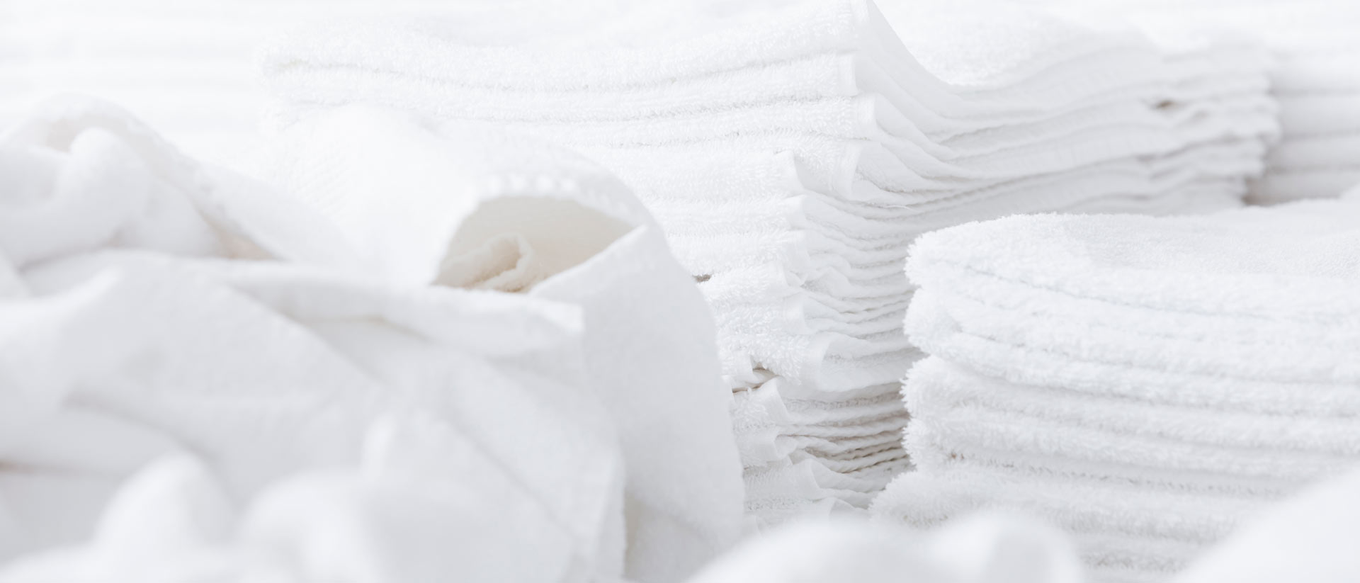 pile of domestically laundered, white towels