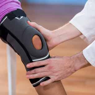 Doctor examining knee brace