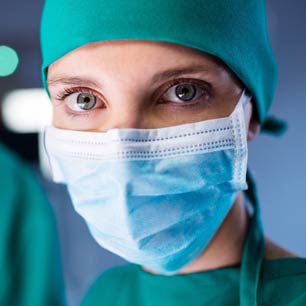 Doctor wearing surgical mask and gown