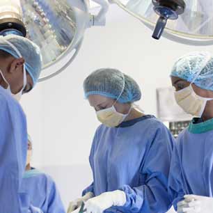 Doctors in scrubs and surgical textiles