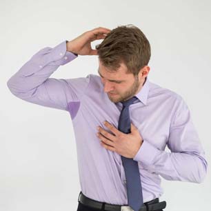 Man sweating through dress shirt