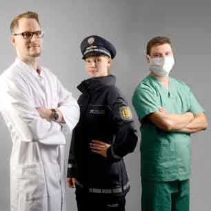 Flight attendant, chef, police and doctor wearing uniforms